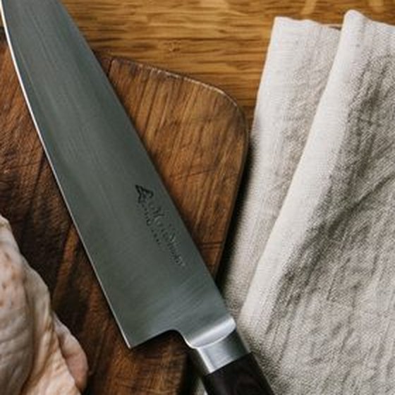 A chef knife on a wooden board