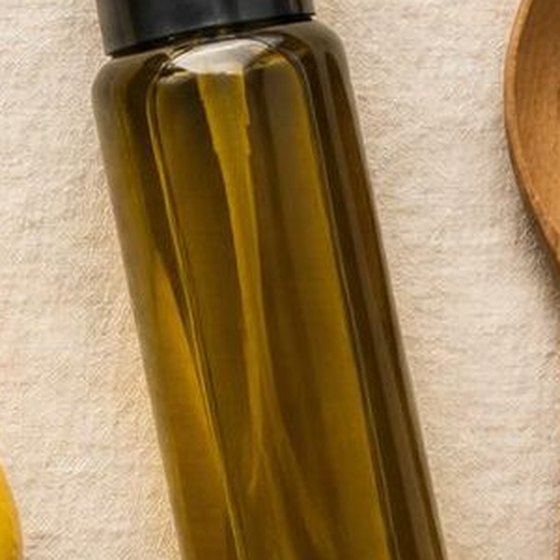 An olive oil spray bottle on linen